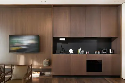 a kitchen with wooden cabinets and a flat screen tv at master Trevi in Rome