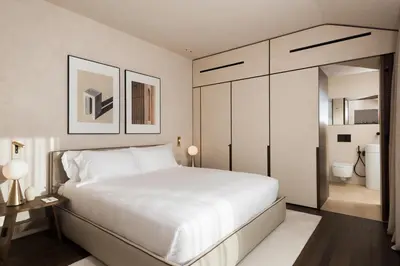 a bedroom with a large white bed and a bathroom at master Trevi in Rome