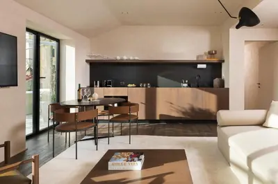 a living room with a table and chairs and a kitchen at master Trevi in Rome