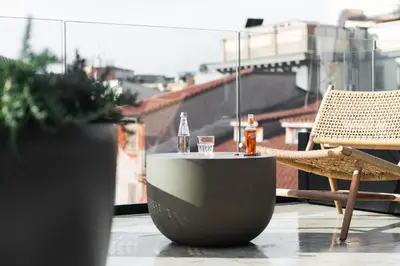 a table with two glasses and a tub on a balcony at master Trevi in Rome