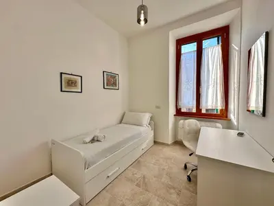 a white room with a bed and a window at Giuli-Etta a Testaccio in Rome