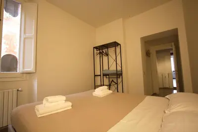 a bedroom with a bed with two towels on it at Cartari Holiday House in Campo de Fiori in Rome