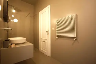 a bathroom with a white sink and a window at Cartari Holiday House in Campo de Fiori in Rome