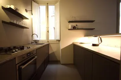 a kitchen with a sink and a window in it at Cartari Holiday House in Campo de Fiori in Rome