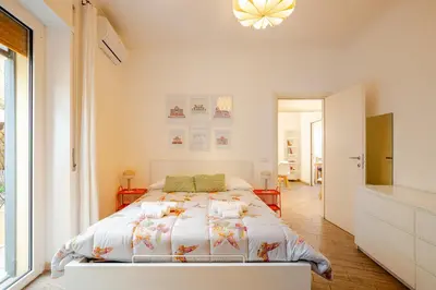 a bedroom with a bed and a large window at Appartamento con terrazza vicino S Pietro in Rome