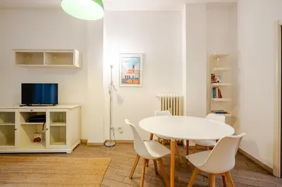 a white dining room with a white table and chairs at Appartamento con terrazza vicino S Pietro in Rome