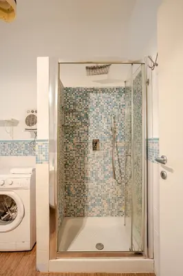 a shower with a glass door in a bathroom at Appartamento con terrazza vicino S Pietro in Rome