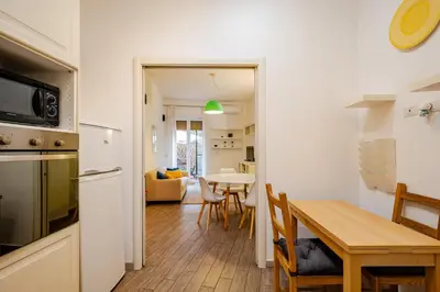 a kitchen and a dining room with a table at Appartamento con terrazza vicino S Pietro in Rome