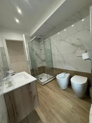 a bathroom with a sink and a toilet and a shower at Dimora Appia in Rome