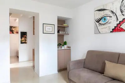 a living room with a couch and a painting on the wall at Vittoria apartment BDB in Rome