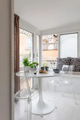 a white dining room with a white table and chairs at Vittoria apartment BDB in Rome