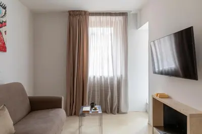 a living room with a couch and a large window at Vittoria apartment BDB in Rome