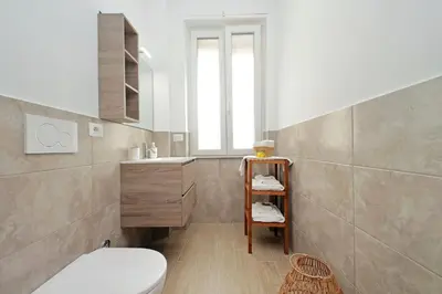 a bathroom with a toilet and a sink at White Wood House in Rome