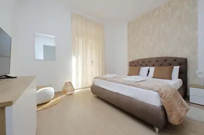 a bedroom with a large bed and a television at White Wood House in Rome