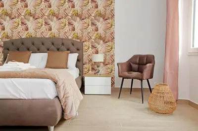 a bedroom with a bed and a chair at White Wood House in Rome