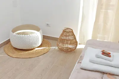 a living room with a bowl and a basket on the floor at White Wood House in Rome
