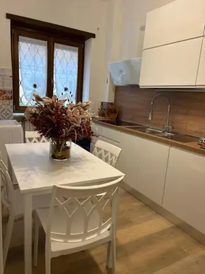 a kitchen with a table with a vase of flowers on it at Vatican suite Rhome in Rome