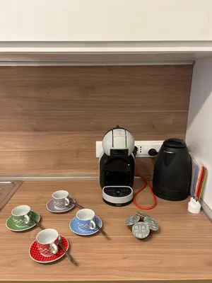 a coffee maker sitting on a counter with cups and saucers at Vatican suite Rhome in Rome