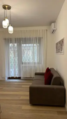 a living room with a couch in front of a window at Vatican suite Rhome in Rome
