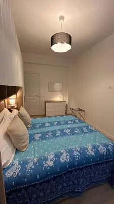 a bedroom with a bed with a blue blanket at Vatican suite Rhome in Rome