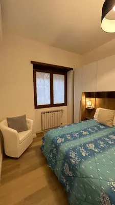 a bedroom with a bed and a chair and a window at Vatican suite Rhome in Rome