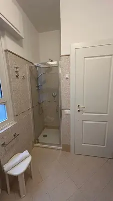 a bathroom with a shower and a toilet and a door at Vatican suite Rhome in Rome