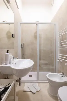 a bathroom with a shower and a sink and a toilet at Colosseo 85 in Rome