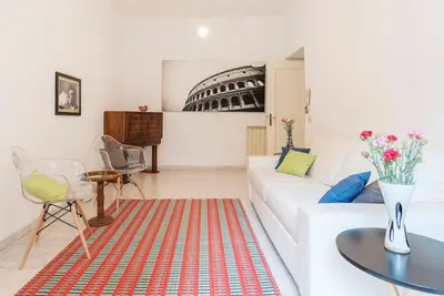 a living room with a white couch and a table at La Bella Vita - Trastevere in Rome