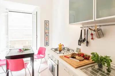 a kitchen with a cutting board with vegetables on it at La Bella Vita - Trastevere in Rome