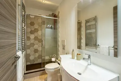a bathroom with a sink and a toilet and a shower at Merulana Suite Apartment in Rome