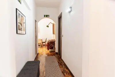 a hallway leading to a dining room with white walls at Merulana Suite Apartment in Rome
