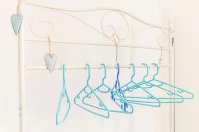 a white rack with blue hearts and hangers at Merulana Suite Apartment in Rome