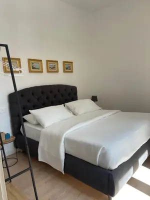 a bed with a black frame in a bedroom at Casa Sara in Rome