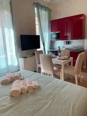a bedroom with a bed with three rolled towels on it at Mary St Peter Vatican Loft in Rome