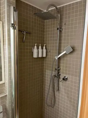 a bathroom with a shower with white bottles at Mary St Peter Vatican Loft in Rome