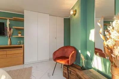 a chair sitting in a room with green walls at Radice Home in Rome