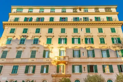a large building with green and yellow windows at Radice Home in Rome