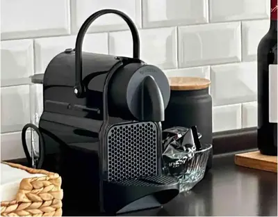 a kitchen counter with a black drying rack and a basket of food at Vatican House big in Rome