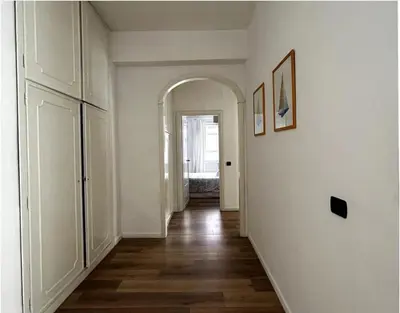 a hallway with an archway in a white room at Vatican House big in Rome