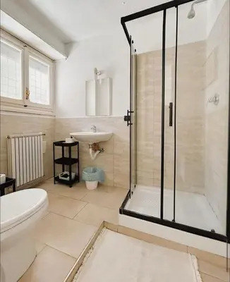 a bathroom with a shower and a toilet and a sink at Vatican House big in Rome
