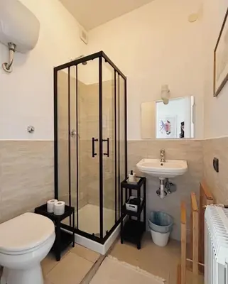 a bathroom with a shower and a toilet and a sink at Vatican House big in Rome