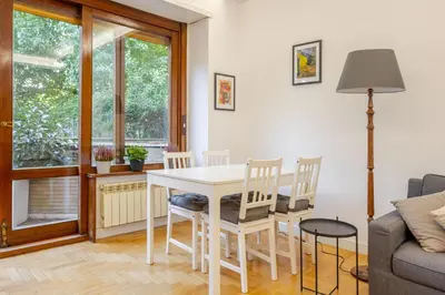 a living room with a white table and chairs at Fleming hill apartments - Free Private Parking & Garden in Rome