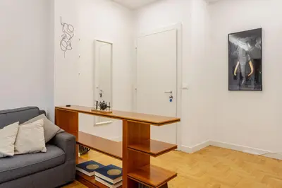 a living room with a couch and a table at Fleming hill apartments - Free Private Parking & Garden in Rome