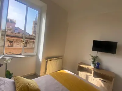 a bedroom with a bed and a large window at Peace Window Roma in Rome