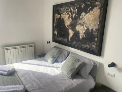 a bedroom with a bed with a map on the wall at Peace Window Roma in Rome