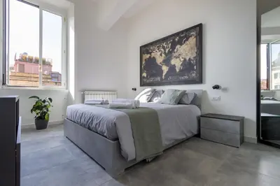 a bedroom with a large bed with a painting on the wall at Peace Window Roma in Rome