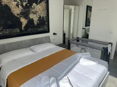 a bed in a room with a map on the wall at Peace Window Roma in Rome