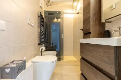 a bathroom with a toilet and a sink at Peace Window Roma in Rome