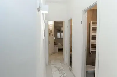 an open door to a hallway with yellow walls at Domus Massimiliani Guesthouse in Rome