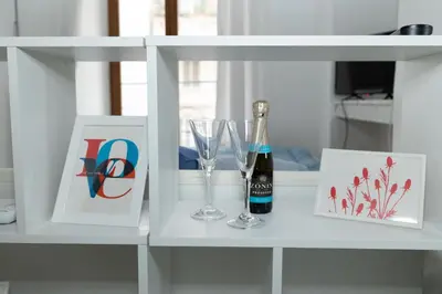 a kitchen with a white refrigerator and a microwave at Domus Massimiliani Guesthouse in Rome